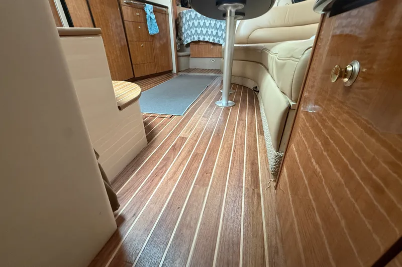 Slide: The Image of Interior of 2003 Maxum 3700 SCR yacht with wood flooring and beige seating. - 50