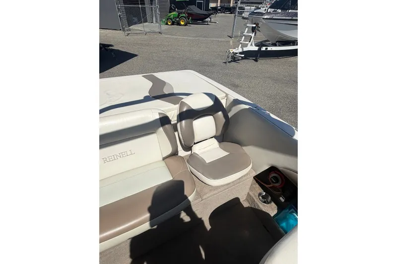 Slide: The Image of 2007 Reinell 204 Fish & Ski boat interior with beige seating and cup holder. - 36