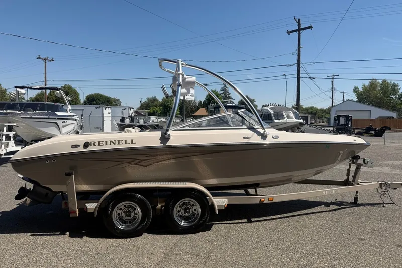 Slide: The Image of 2007 Reinell 204 Fish & Ski boat on trailer, parked outdoors under clear sky. - 7
