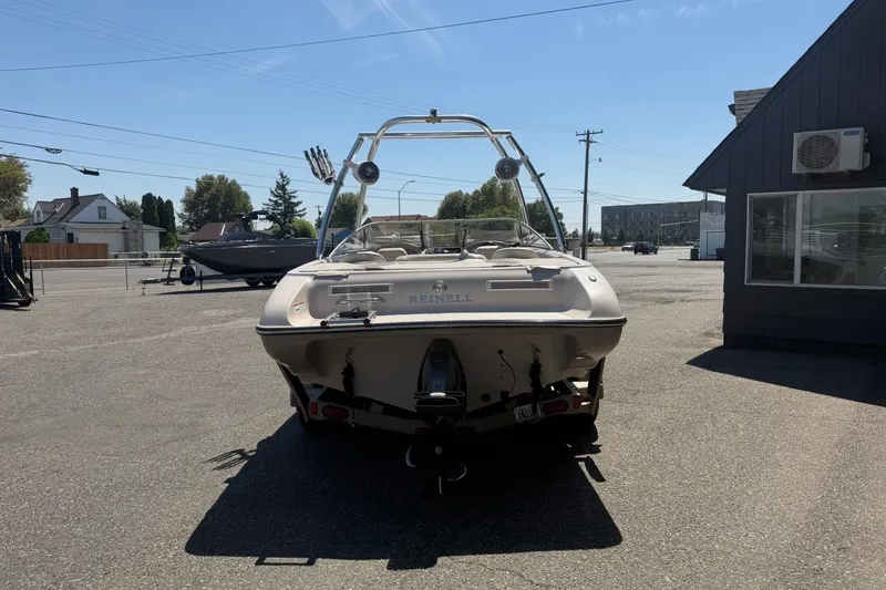 Slide: The Image of 2007 Reinell 204 Fish & Ski boat parked outdoors on a sunny day. - 4