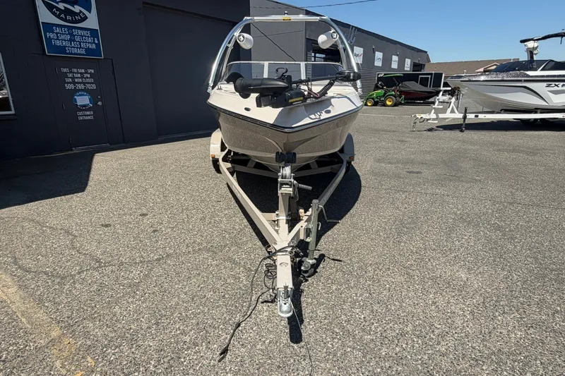 Slide: The Image of 2007 Reinell 204 Fish & Ski boat on trailer in a marine dealership lot. - 9