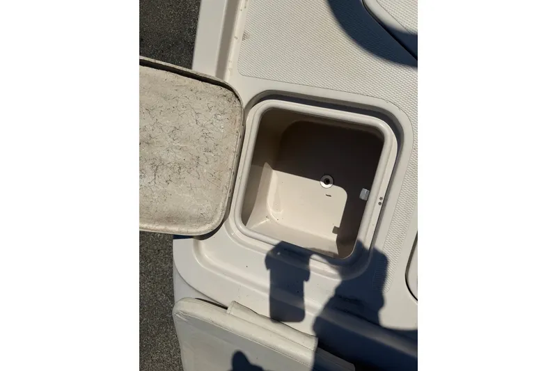 Slide: The Image of Open storage compartment on a 2007 Reinell 204 Fish & Ski boat deck. - 46