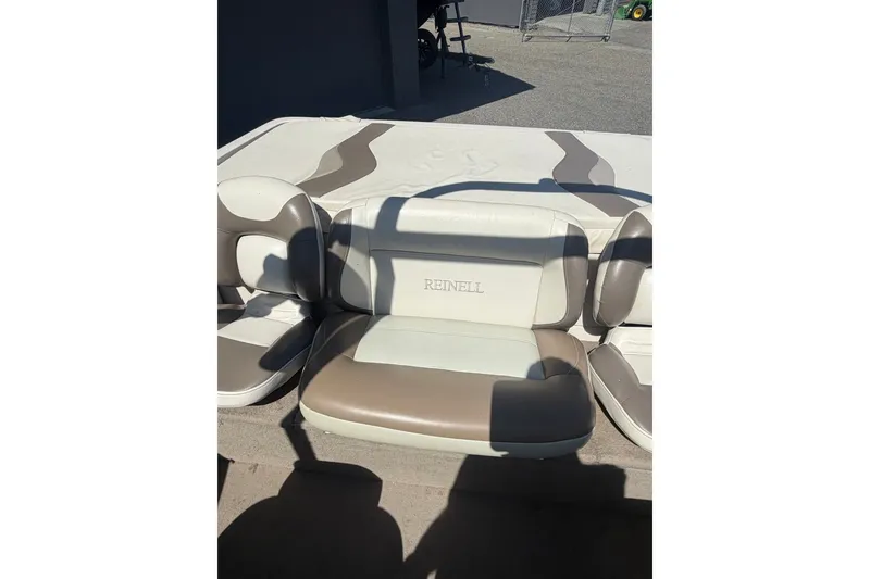 Slide: The Image of 2007 Reinell 204 Fish & Ski boat interior with beige and white seating. - 38