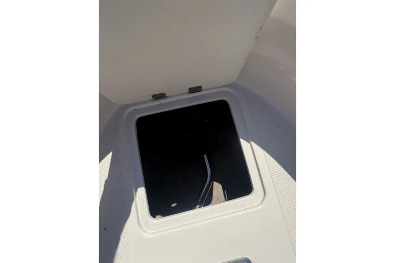 Slide: The Image of Open storage compartment on a 2007 Reinell 204 Fish & Ski boat. - 28