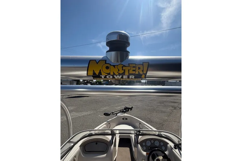 Slide: The Image of 2007 Reinell 204 Fish & Ski boat with Monster Tower accessory under clear blue sky. - 20