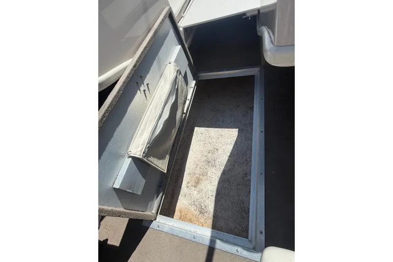 Slide: The Image of Open storage compartment in a 2007 Reinell 204 Fish & Ski boat. - 34