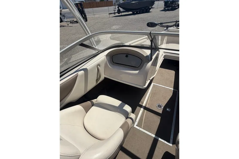 Slide: The Image of 2007 Reinell 204 Fish & Ski boat interior with beige seating and carpeted floor. - 23