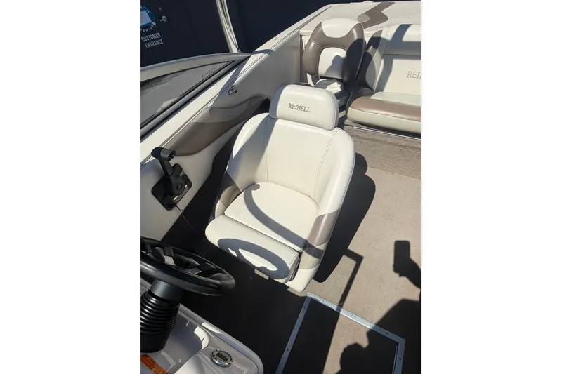 Slide: The Image of 2007 Reinell 204 Fish & Ski boat interior with beige seating and steering wheel. - 33