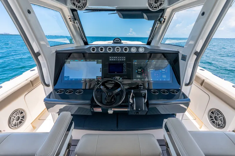 Slide: The Image of 2024 Solace 41CS boat helm with advanced navigation displays and ocean view. - 22