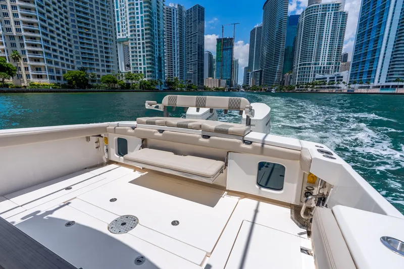 Slide: The Image of 2024 Solace 41CS boat cruising in urban waterfront with skyscrapers in background. - 25