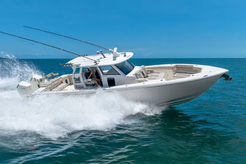 Slide: The Image of 2024 Solace 41CS boat cruising on open water under clear blue skies. - 14