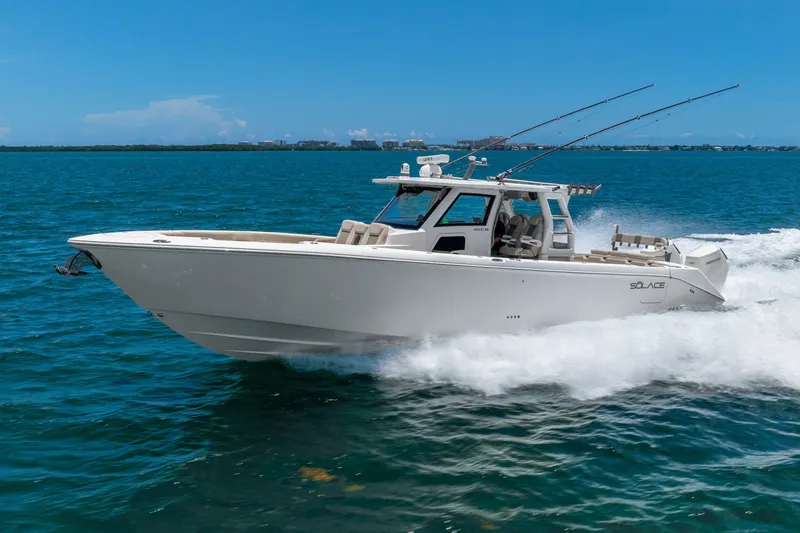 Slide: The Image of 2024 Solace 41CS boat cruising on blue ocean waters under clear skies. - 15
