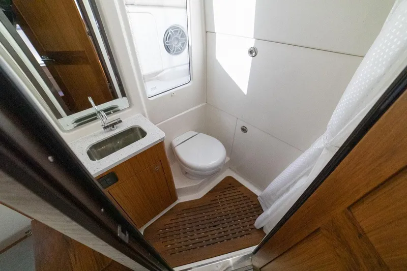 Slide: The Image of Manufacturer Provided Image: 2024 Solace 41 CS boat bathroom with sink, toilet, and wooden flooring. - 48