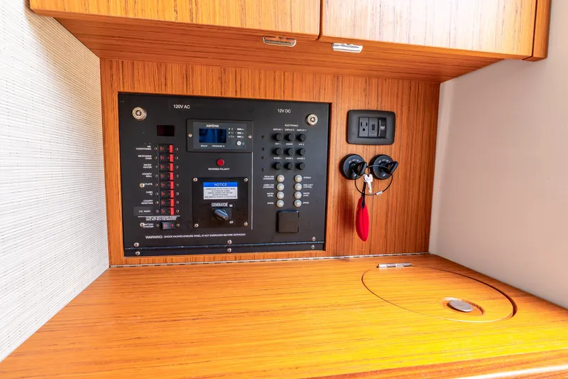Slide: The Image of 2024 Solace 41CS electrical control panel with wood finish and power outlets. - 45