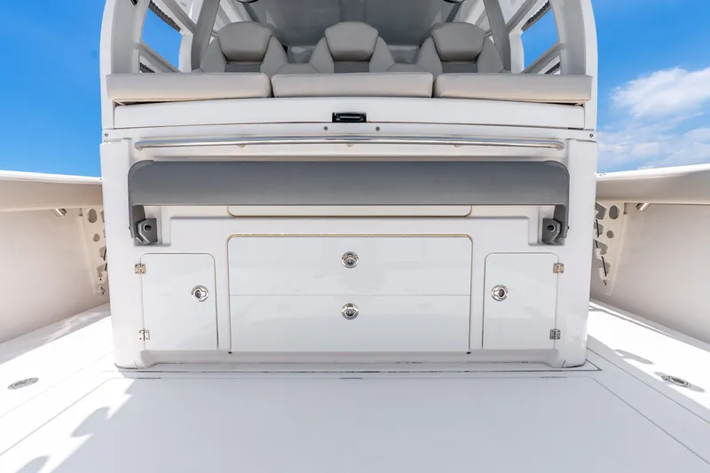 Slide: The Image of 2024 Solace 41CS boat interior with sleek storage compartments and seating, under a clear blue sky. - 31