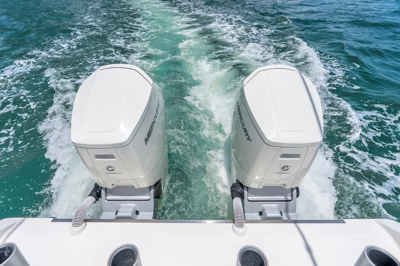 Slide: The Image of Twin Mercury outboard engines powering a 2024 Solace 41CS boat on open water. - 17