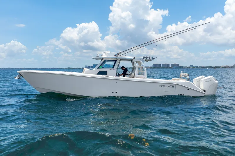 The Image of 2024 Solace 41CS boat cruising on open water under a clear blue sky. - 0