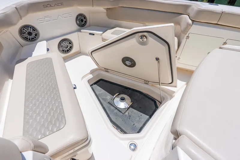 Slide: The Image of 2024 Solace 41CS boat interior with open storage compartment and cushioned seating. - 40