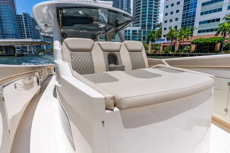 Slide: The Image of Luxurious 2024 Solace 41CS boat interior with plush seating, docked near modern cityscape. - 36