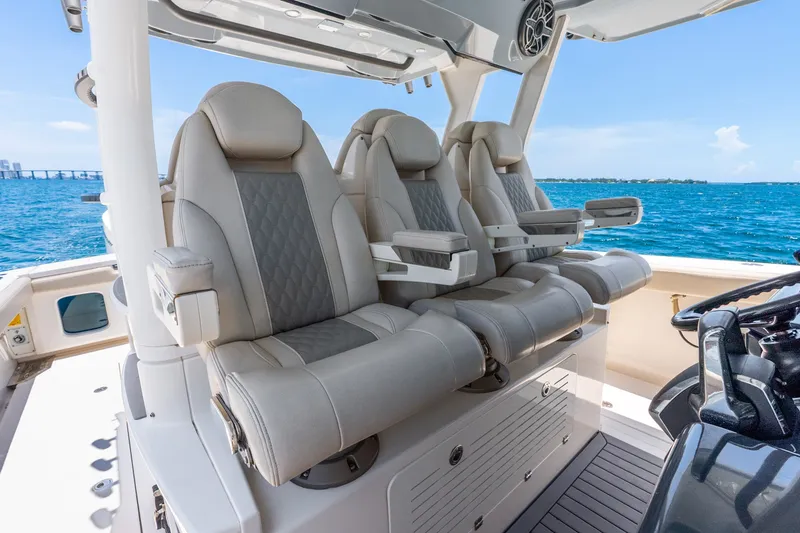 Slide: The Image of Luxurious seating on 2024 Solace 41CS boat, overlooking blue ocean waters. - 20