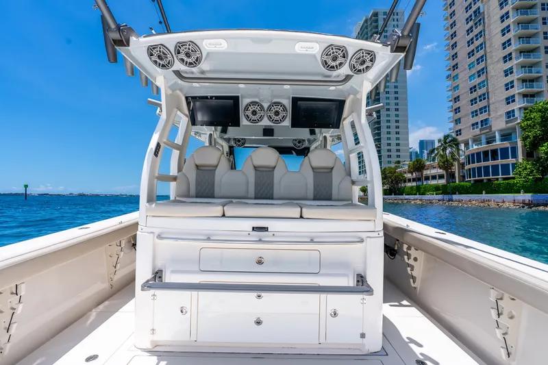 Slide: The Image of 2024 Solace 41CS boat interior with luxury seating and modern amenities, docked near waterfront buildings. - 29