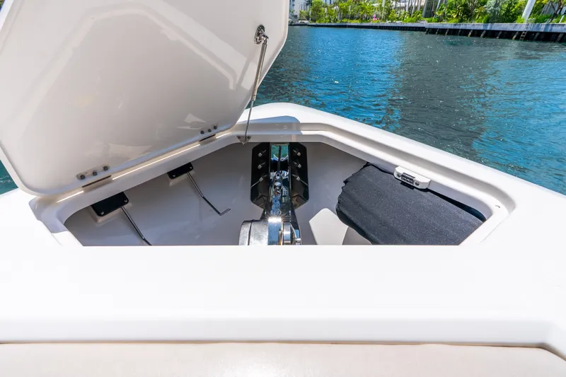 Slide: The Image of Open anchor compartment of 2024 Solace 41CS boat by the water. - 38