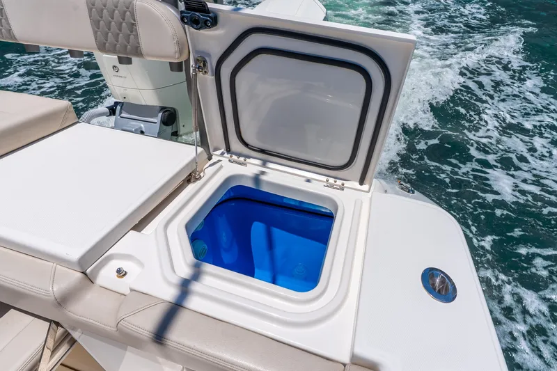 Slide: The Image of Open storage compartment on 2024 Solace 41CS boat, with ocean waves in background. - 27