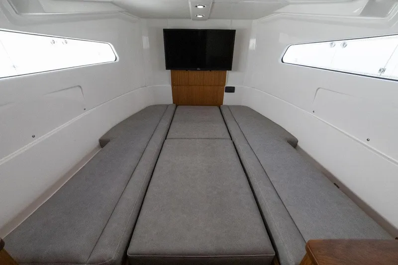 Slide: The Image of Manufacturer Provided Image: 2024 Solace 41 CS cabin interior with seating and TV. - 47