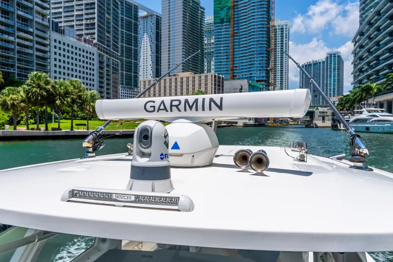 Slide: The Image of 2024 Solace 41CS boat with Garmin radar, cruising in urban waterway. - 24