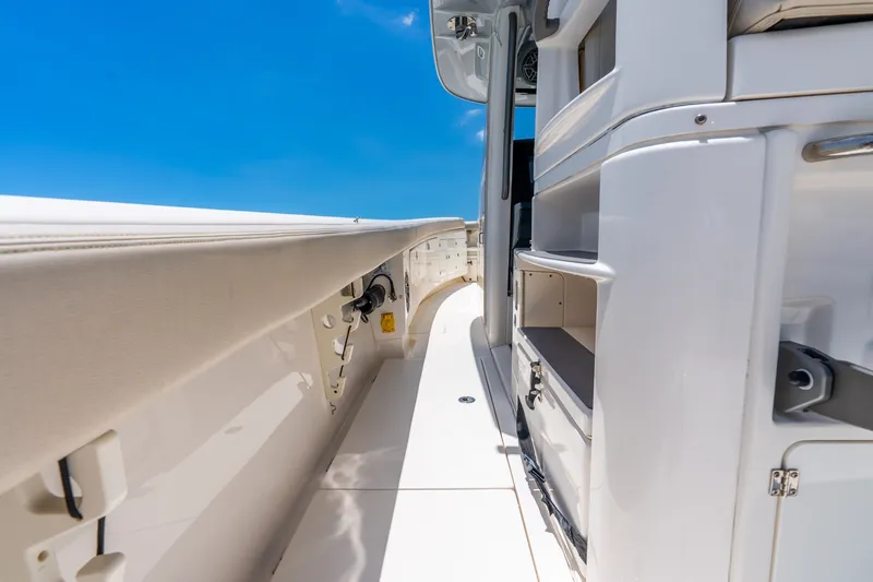 Slide: The Image of 2024 Solace 41CS boat interior with sleek white design under clear blue sky. - 43