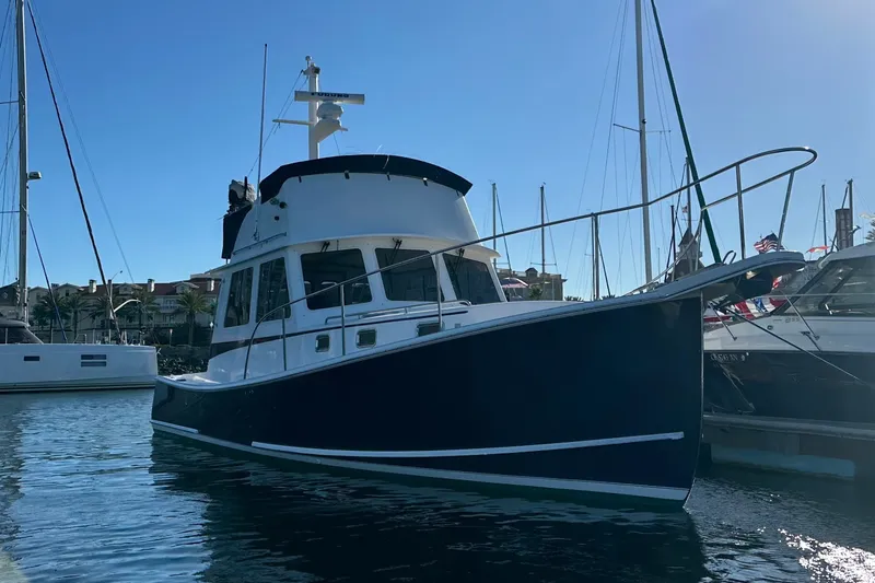 The Image of 2001 Northern Bay 36 boat docked in a marina under clear blue sky. - 0