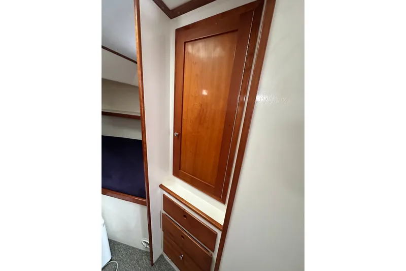 Slide: The Image of Interior of 2001 Northern Bay 36 boat featuring wooden cabinetry and storage drawers. - 27