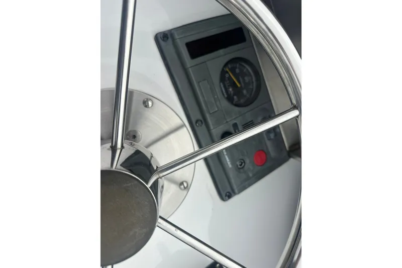 Slide: The Image of Steering wheel and control panel of a 2001 Northern Bay 36 boat. - 29