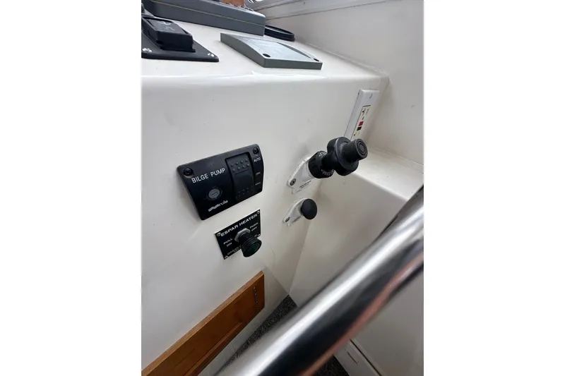 Slide: The Image of Control panel of a 2001 Northern Bay 36 boat, featuring bilge pump and heater controls. - 13