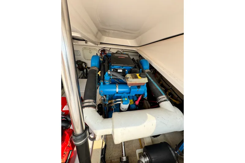 Slide: The Image of Engine compartment of a 2008 Tiara 3000 Open boat, showcasing detailed components. - 32