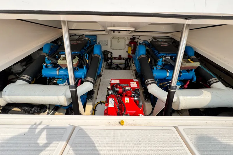 Slide: The Image of Engine compartment of a 2008 Tiara 3000 Open boat, featuring dual engines and equipment. - 29