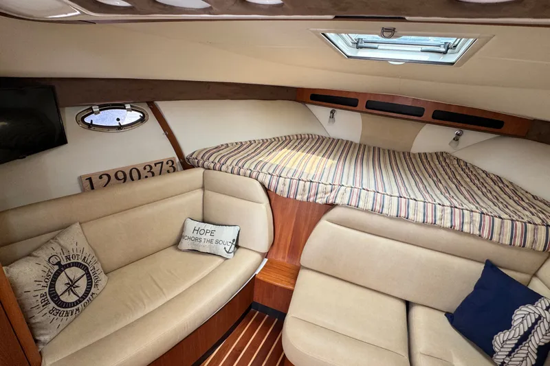 Slide: The Image of Interior of 2008 Tiara 3000 Open yacht with cozy seating and striped bedding. - 19