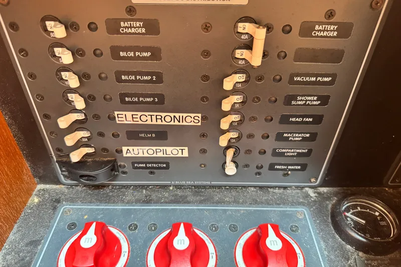 Slide: The Image of Control panel of a 2008 Tiara 3000 Open boat with labeled switches and gauges. - 27