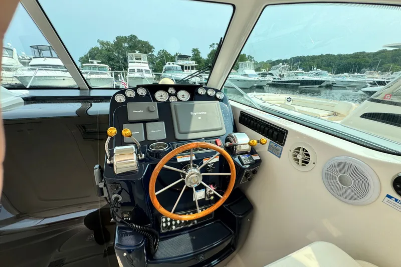 Slide: The Image of Helm of 2008 Tiara 3000 Open boat with steering wheel and navigation controls. - 7