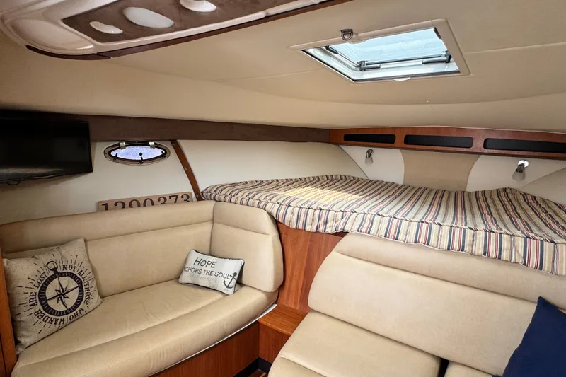 Slide: The Image of Interior of 2008 Tiara 3000 Open yacht with cozy seating and striped bedding. - 21