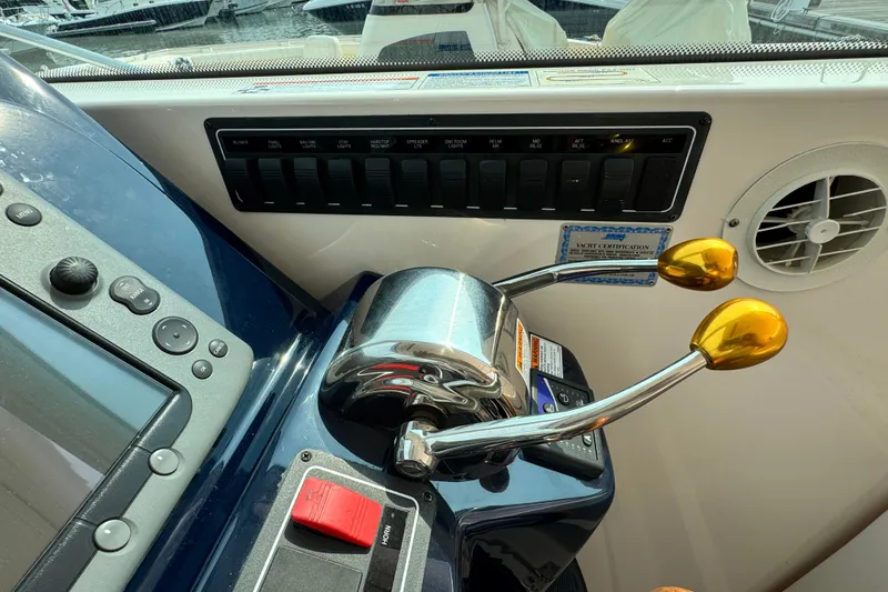 Slide: The Image of Control panel of a 2008 Tiara 3000 Open yacht with throttle levers and switches. - 10