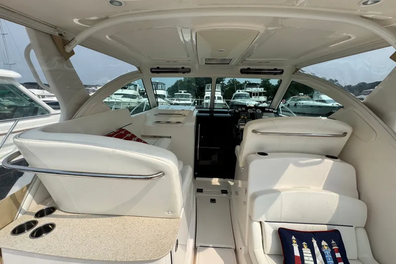 Slide: The Image of Interior of a 2008 Tiara 3000 Open yacht with white seating and helm. - 6