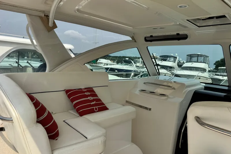 Slide: The Image of Interior of a 2008 Tiara 3000 Open yacht with white seating and red cushions. - 4