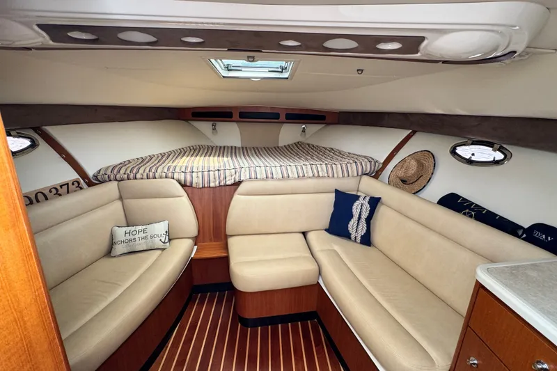 Slide: The Image of Interior of a 2008 Tiara 3000 Open yacht with cozy seating and striped bedding. - 17