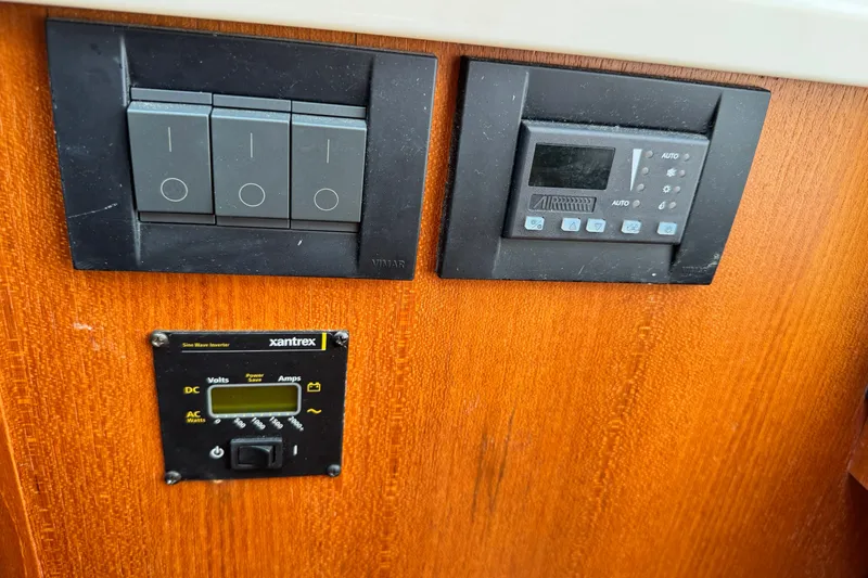 Slide: The Image of Control panel on 2008 Tiara 3000 Open boat with switches and Xantrex inverter display. - 24
