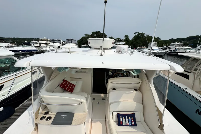 Slide: The Image of 2008 Tiara 3000 Open yacht docked at marina, featuring spacious seating and modern amenities. - 16