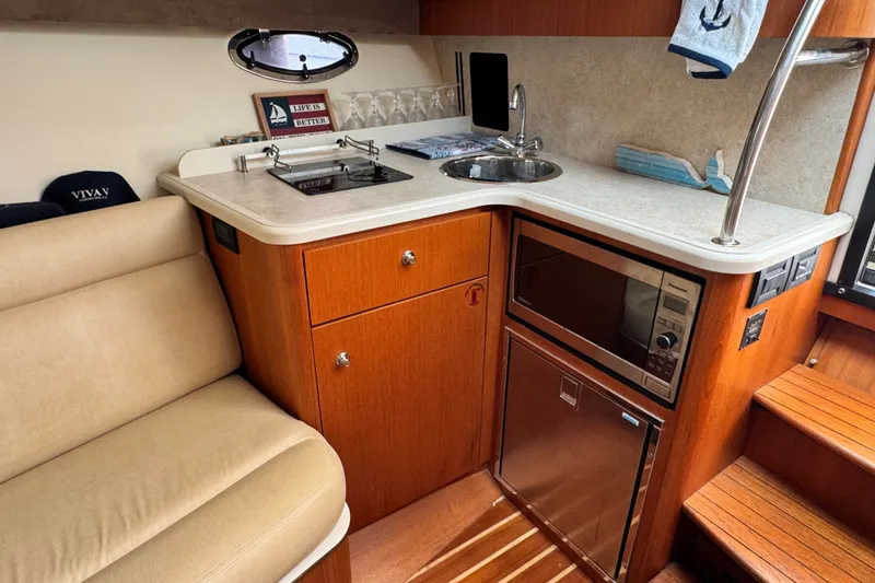 Slide: The Image of Compact kitchen area in a 2008 Tiara 3000 Open yacht with sink and microwave. - 23