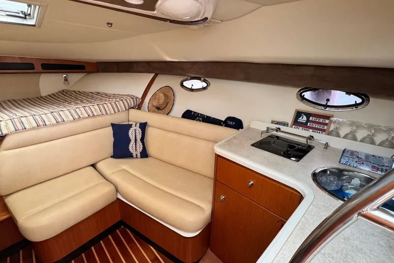 Slide: The Image of Interior of 2008 Tiara 3000 Open yacht with cozy seating and compact kitchen area. - 18