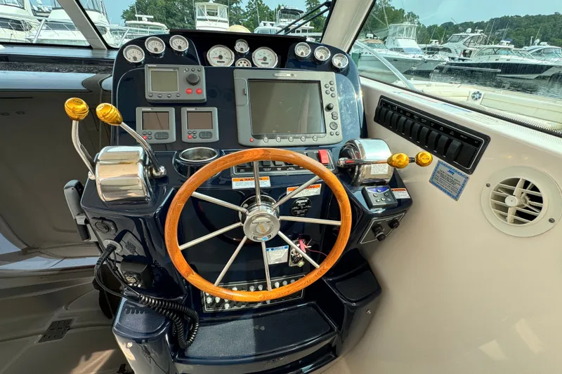 Slide: The Image of Helm of 2008 Tiara 3000 Open boat with wooden steering wheel and navigation controls. - 9