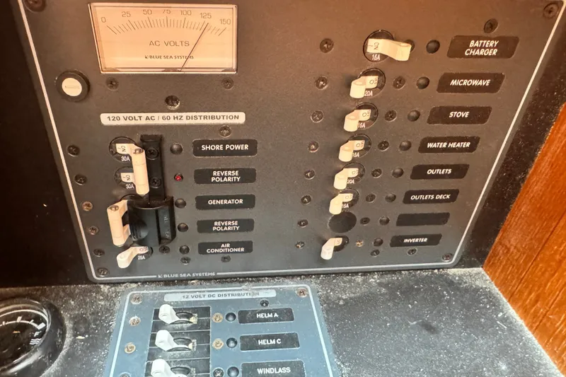 Slide: The Image of Electrical panel of a 2008 Tiara 3000 Open boat with various circuit breakers. - 28